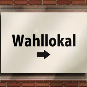 Ein Schild mit der Aufschrift "Wahlllokal" und einem Pfeil