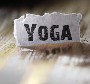 Eine Stück Papier mit dem Wort "Yoga" in Großdruckbuchstaben